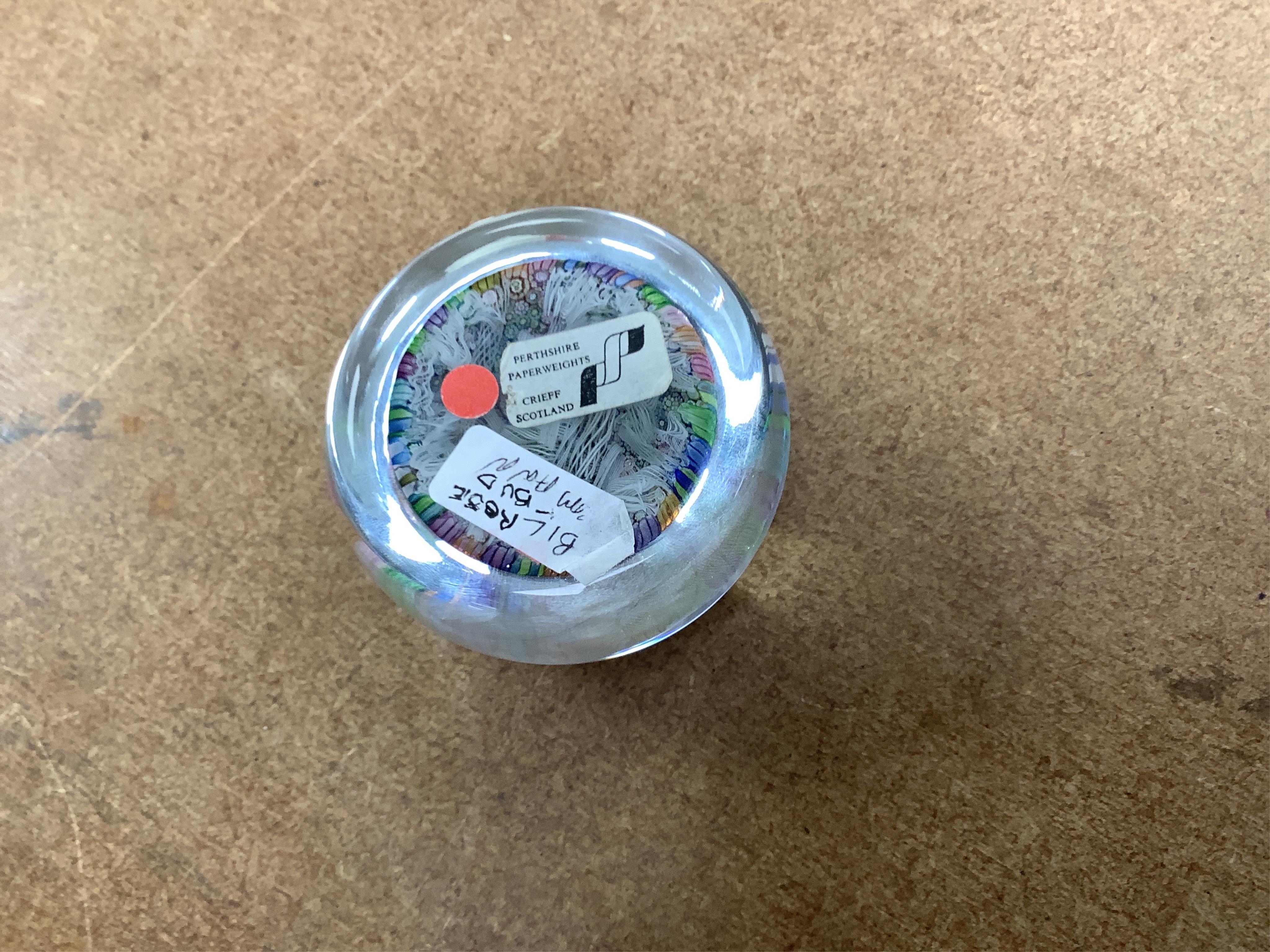 Two boxed Perthshire glass paperweights, the first faceted with latticino twists and complex canes, the second close packed millefiori paperweight, 62/400